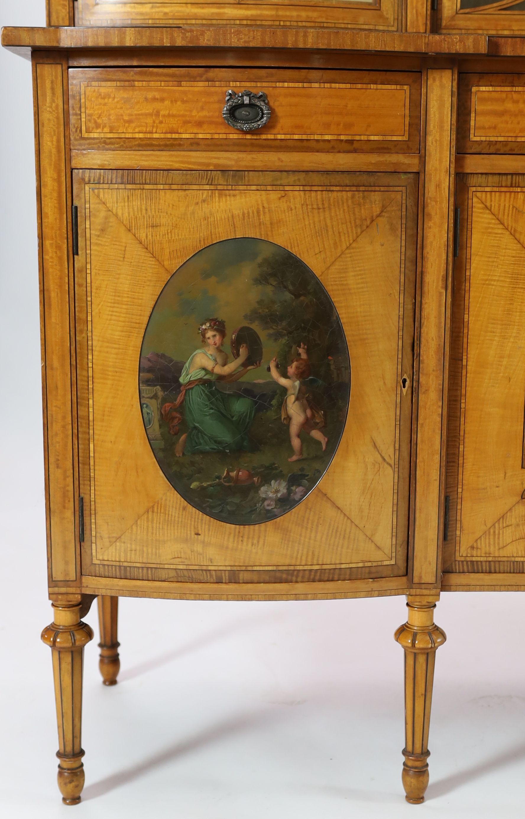 An Edwardian Sheraton revival ebony strung satinwood display cabinet, W.190cm D.47cm H.205cm